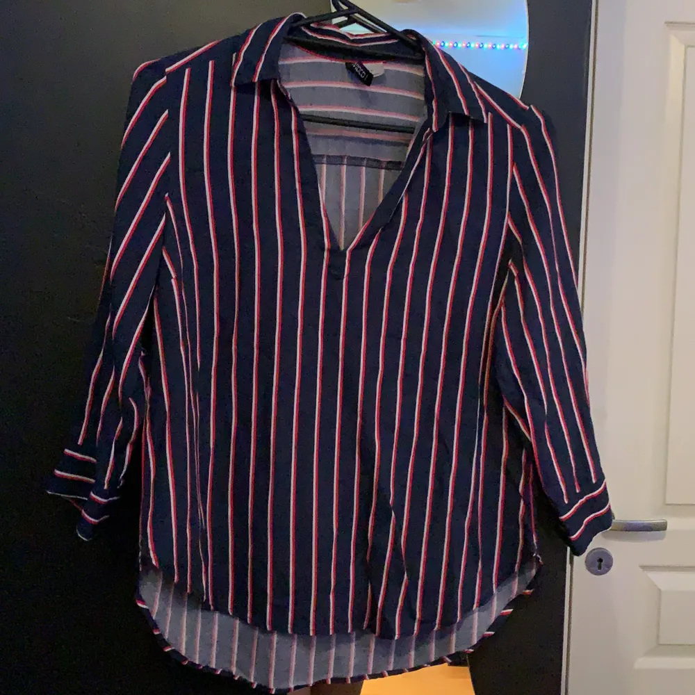 Säljer denna skitsnygga skjortan/blusen från H&M. Använd typ 3 gånger så i toppskick. Mörkblå med vita & röda streck. Armarna är 3/4.Frakt 63kr. Blusar.