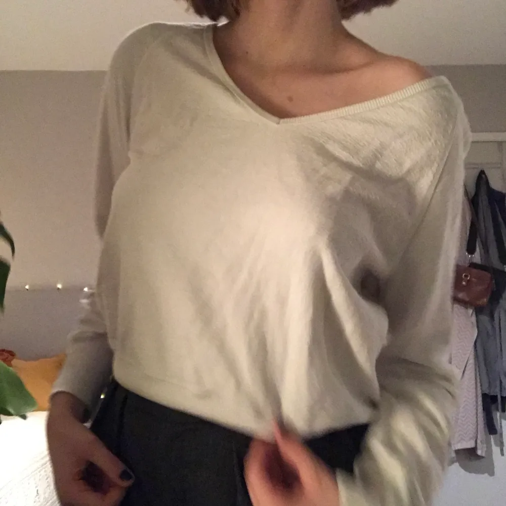 Croppad vit V-ringad tröja. Tjock mudd längst ner på tröjan. Fint fint skick. Storlek XS, men sitter oversized på mig som är S. Neuletakit & Villapaidat.