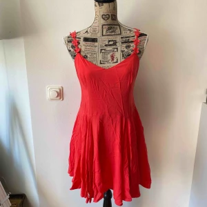  - Vacker korallfärgad klänning med fina band och snörning i ryggen.