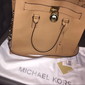  - Säljer min helt oanvända äkta Michael Kors väska, modell Hamilton large. Färg beige.