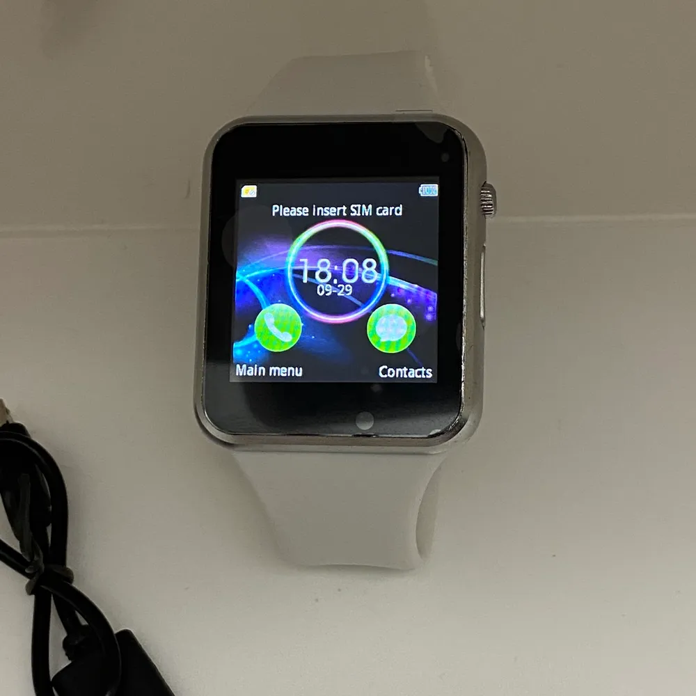Brand New! Generation 6 Smartwatch comes with Charger and User Manual. Does require SIM card, this Watch has a lot of great features! Access your Facebook, Twitter, Notifications, even has a camera where you can take a picture directly on your watch! . Accessoarer.