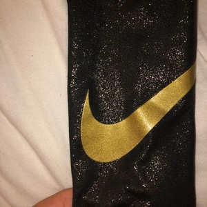 Träningsbyxor Nike  - Super fina träningsbyxor från Nike. Glittrar i guld och limited edition. Använd å tvättade endast en gång. Storlek S men sitter som en S/XS. Kom privat för mer bilder, köparen står för frakt
