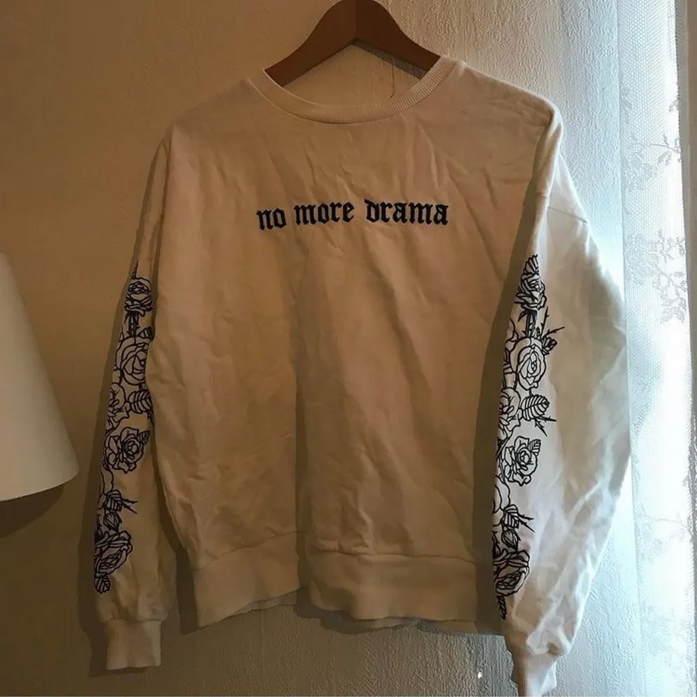 White sweater with ‘no more drama’ written over the chest, rose pattern down the sleeves. . Hoodies.