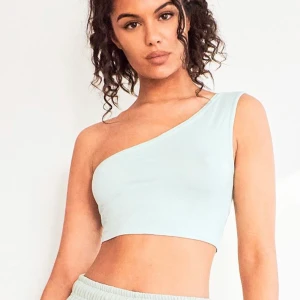 One shoulder crop top  - Helt ny one shoulder crop top med lappen kvar i storlek s/xs. Jättefin och fin färg( färgen är en smula mörkare tycker jag) men bara inte min stil!                                                  24 kr frakt om inte upphämtning i Stockholm! 