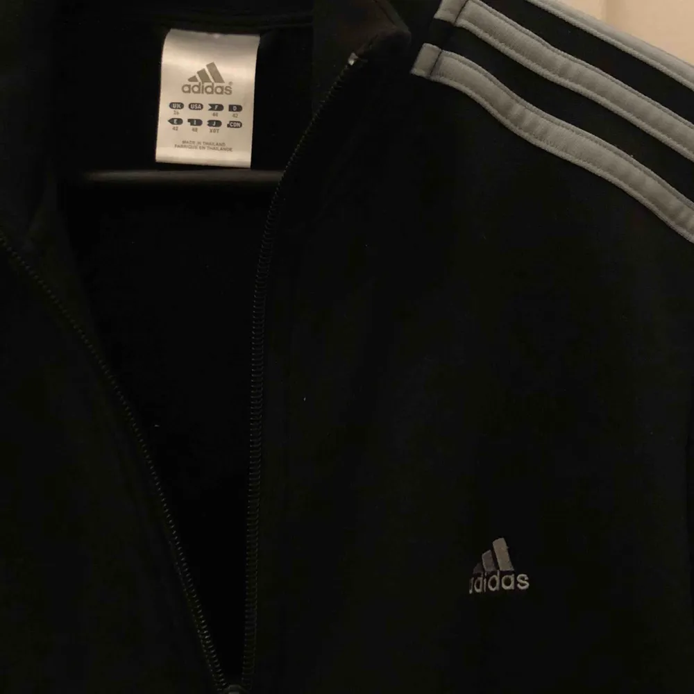 Jättecool svart Adidas tröja med grå detaljer!! Det står på lappen att den är i storlek 42, men den är extremt liten i storleken. Köpare står för frakt <33.. Hoodies.