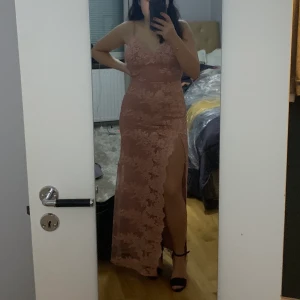 Rosa spets balklänning - Rosa spets balklänning från fashionnova. Säljes då den är för liten för mig, jag får inte upp dragkedjan helt i ryggen (bild 3). Klänningen är aldrig använd utan endast testad. Plagget är i bra skick. Jag är 155cm och bär normalt S eller 36. Köparen står för frakten, jag kan även mötas upp i Stockholm/ Sundbyberg. 