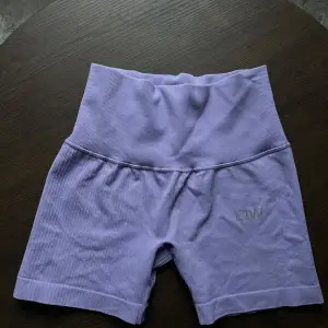 Säljer ett par snygga lila ribbade träningsshorts från ICANIWILL. De är högmidjade och perfekta för gymmet eller yoga. Materialet är stretchigt och bekvämt, vilket ger en bra passform. Shortsen är i mycket bra skick och redo för nya äventyr!💜