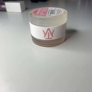 Krämig highlighter duo och gloss - Säljer en krämig highlighter i en liten burk med genomskinligt lock. Den har en skimrande ljusrosa nyans som ger en fin lyster till huden. Perfekt för att framhäva kindben och andra ansiktsdrag. Lätt att applicera med fingrarna eller en borste.
