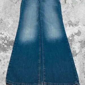 Säljer ett par snygga blå jeans med riktigt breda ben. De har en cool vintage look med ljusare partier på låren. Perfekta för en retro-stil eller bara för att sticka ut lite extra. Passar både till vardags och fest!  Midja: 80 cm.     Total längd: 105 cm