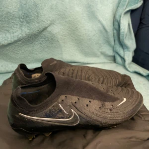Nike Phantom GX 2  - Säljer dessa Nike phantom gx 2 skor då dem inte längre kommer till användning. Använda under Gothia Cup och några få andra matcher. Är i väldigt fint skick men saknar skosnören som jag tog av för egen komfort. Rengörs noggrant innan frakt och jag ska försöka hitta skosnörenrna. Köpta för omkring 3000kr