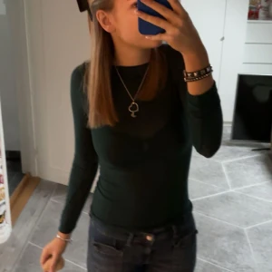 Intimissimi grön topp i kashmir - Säljer den trendiga toppen från intimissimi i  mörkgrön. Perfekt för lager-på-lager eller att bära som den är. Toppen har en enkel design som gör den lätt att matcha med olika outfits. Den är i kashimir och super bekväm. Super trendig och bara använd få gånger. 