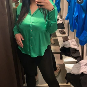 Grön blus med knappar - Snygg grön blus med knappar framtill och v-ringning. Perfekt för en stilren look. Långärmad design med en lös passform som ger en bekväm känsla. Köpt från zara men sällan använd 