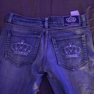 Vill sälja dessa Victoria Bäckhem jeansen för är inte riktigt min stil längre. -  Ett par blåa Victoria Beckham jeans med blåa kronor på fickorna, dom är i jätte fint skick nästan aldrig använt. skulle säga dom var y2k. 