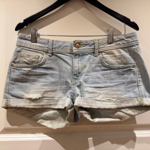 Ljusblå jeansshorts från Divided by H&M - Snygga ljusblå jeansshorts från Divided by H&M med upprullade benslut och klassisk femficksdesign. Perfekta för en avslappnad sommarlook. 🩳✨