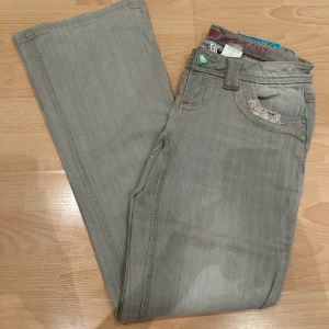 Grå bootcut jeans - Snygga grå bootcut jeans från Rainbow. Jeansen har en klassisk femficksdesign och knappar som ger en cool kontrast. Perfekta för en avslappnad stil. Älskar verkligen dessa och är så fina på🩷