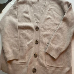 Beige kofta från H&M - Jättemysig kofta från h&m, den är varm och passar perfekt nu i vinter! Färgern är beige/grå, som framgår lite mer på den andra bilden!