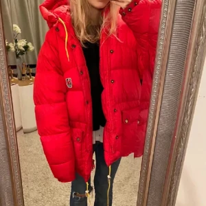 Röd dunjacka från Fjällräven - Snygg och varm röd dunjacka från Fjällräven med huva och praktiska fickor. Jackan har knappar och dragsko i midjan för justerbar passform. Perfekt för kyliga dagar! Storlek xxs och den är i en äldre modell!🩷
