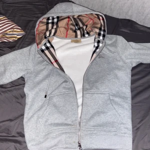 Grå huvtröja från Burberry - Använt 1 gång. Längd 60 cm