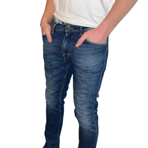 Tiger of Sweden jeans - Snygga blå jeansbyxor med en klassisk design. De har en dragkedja och knappar framtill. Perfekta för en avslappnad stil.
