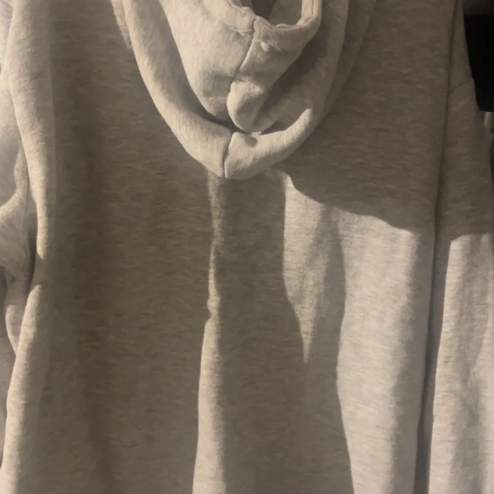 Säljer en grå hoodie från McKenzie i storlek XL. Den har en dragkedja framtill och en justerbar huva med snören. Perfekt för en avslappnad stil och passar bra till både höst och vår och även vintern. Hoodien är i bra skick och superbekväm att ha på sig. Pris går att diskutera!. Tröjor & Koftor.