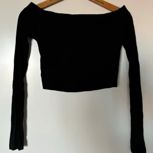 Svart offshoulder topp - Snygg svart offshoulder topp med långa ärmar. Perfekt för en kväll ute eller en fest. 