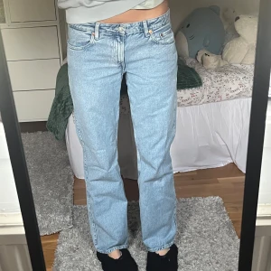 Ljusblå jeans från Weekday - Snygga ljusblå Weekday jeans med klassisk femficksdesign och knappgylf. De har en rak passform och är perfekta för en avslappnad stil. Storlek W29 L32 i modellen Arrow Low, säljer pga för korta för mig och jag är 175. 