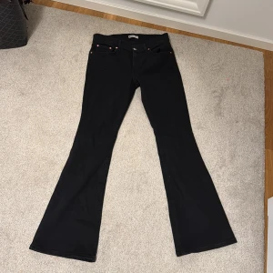 Svarta bootcut jeans - Snygga svarta bootcut jeans med klassisk design. Perfekta för en stilren look. De har en bekväm passform och är ett måste i garderoben.
