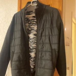 Svart quiltad jacka. Drag kedjan är tyvärr sönder men går och fixa  - Snygg svart quiltad jacka med dragkedja och långärmade ärmar. Perfekt för kyligare dagar med sin stilrena design och bekväma passform.