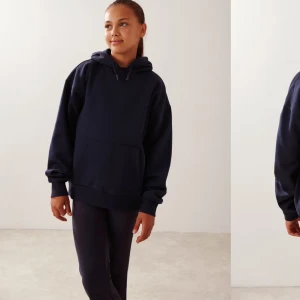 Mörkblå hoodie - Säljer en stilren mörkblå hoodie med en klassisk design. Den har en stor ficka framtill och justerbar huva med dragsko. Perfekt för en avslappnad look.