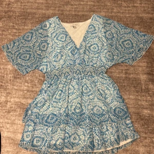 Blå/vit klänning med mönster - Säljer en somrig blå och vit klänning med ett unikt mönster💗. Jätte fin klänning att ha på sig till Havet i sommar.  Helt nytt skick, helt oanvänd 💗 pris kan diskuteras 💗