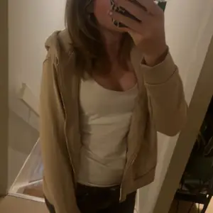 Säljer en beige hoodie från H&M i storlek S. Den är supermjuk och bekväm, perfekt för vardagsbruk. Hoodien har en dragkedja framtill och en skön huva. Använd några gånger men i bra skick. Perfekt för höst och vår!