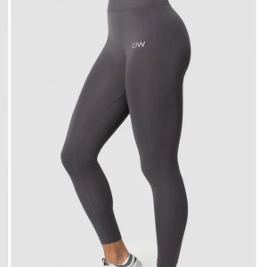Leggings från ICANIWILL GRAPHITE - Snygga leggings från ICANIWILL med hög midja och tight passform. Perfekta för träning med en stilren design och logotyp på benet. Supersköna på🫶🏽