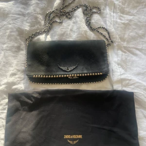 Zadig & Voltaire Rock clutch - Säljer min jättesnygga Zadig väska då jag tyvärr inte använder den längre. Den är i väldigt fint skick. Det enda är att nitarna på den övre raden framifrån har blivit lite guldaktiga (se första bilden) men det är inget som syns eller tänker på. Köpte den för 4500 kr. Skriv för mer info! 