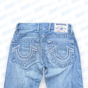 True Religion Jeans💙 - Storlek W30💙 • Längd: 99 cm • Midjemått: 41 cm • benöppning: 19,5 cm • lårbredd: 26 cm • OBS! Riven design över benen, två väldigt små bruna fläckar på vänster framficka. • Hör gärna av dig vid intresse💙