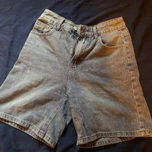 Grå jeansshorts- perfekt längd - Snygga grå jeansshorts med klassisk femficksdesign och knappgylf. Perfekta för en avslappnad stil. De har en normal passform och är tillverkade i slitstarkt denim.