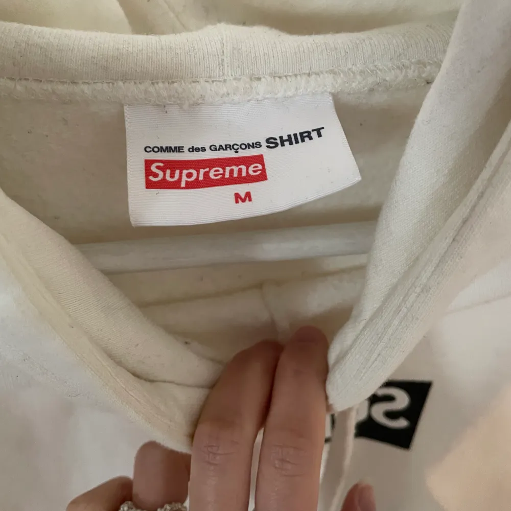 A hoodie from a collaboration between monster fashion icons Supreme and Comme des Garcons.  Condition: Very Good Size for women: L/ XL Size for men: M Message for more pictures.. Hoodies.