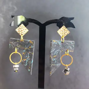 Handmade earrings made of polymer clay with gold details 