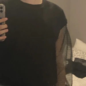 Svart tröja - En svart tröja med genomskinliga ärmar. Sparsamt använd. ”Barnstorlek” men passar xs/s.  Skriv till mig vid frågor eller fler bilder 💕