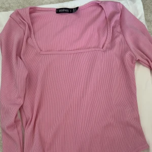 Rosa body - En rosa body, i nyskick då den aldrig är använd pga fel storlek.