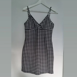Klänning - Hundtandsmönstrad svart/vit klänning, åtsittande/tight. Endast provad. 