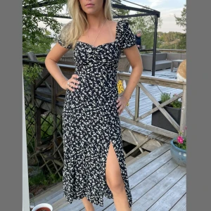 Blommig klänning från &Otherstories - Svartblommig klänning från Stories med ouffärmar och slits. Sitter väldigt fint runt kroppen. Storlek 36, men något liten på mig som är en 36/38! Fint skick!