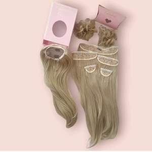 Synthetic hair  Imcludes:  All clip ins  Ponytail  2 buns  Light golden blonde 