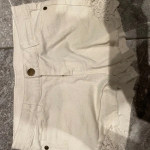 Jeansshorts 134 - Vita jeansshorts. Lite spets. Säljer pga stor garderobrensning. Kika gärna på mina andra annonser, säljer mycket. Samfraktar gärna:) 