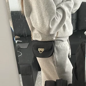 Handväska - Säljer min söta lilla svarta handväska med extra axelband 