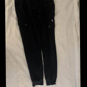 Ralph Lauren Cargo Sweatpants Aviator Navy - 185/84A Sitter för små på mig så därför typ aldrig använda. Köpt flera år sedan och bara legat i min garderob.