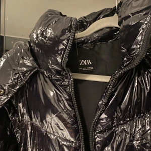 Väst och jacka  - En jacka som också är en väst. Amarna på jackan går att ta bort och dragkedjan döljs av en söm så den syns ej. Nyskick använd Max 2 gg. Luvan går att ta av. 