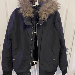 Jacka med pälsluva  - Säljer en HM jacka med päls. Strl L. Skön och mysig