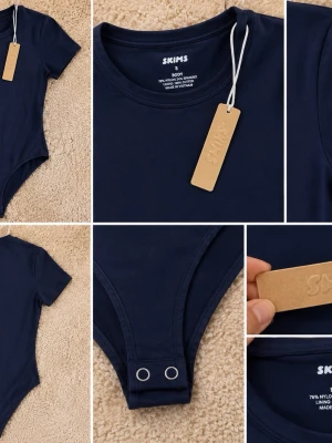 Mörkblå body från Skims - Snygg mörkblå body från Skims med rund halsringning och korta ärmar. Tillverkad i mjukt stretchigt material med tryckknappar i grenen för enkel på- och avtagning. Perfekt att styla till jeans eller kjol för en clean look.