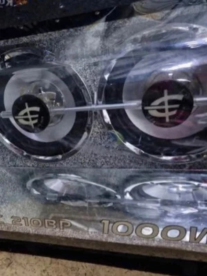 Caliber 1000W bilhögtalare - Säljer en Caliber 1000W baslåda med dubbla element i silver och svart. Högtalaren har en robust design med glasfront och tydlig logga. Perfekt för dig som vill ha kraftfullt ljud i bilen. Anslutningarna är placerade på sidan av lådan.