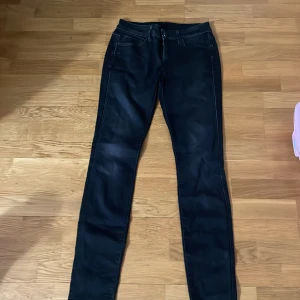 Svarta jeansbyxor från G-star - Snygga svarta jeansbyxor med en slim passform. De har klassiska femficksdetaljer och en dragkedja. Perfekta för en stilren look haft dom i drygt 2 månader bra passform och sköna på märket är G-star för fler frågor är det bara att höra av dig via dm!